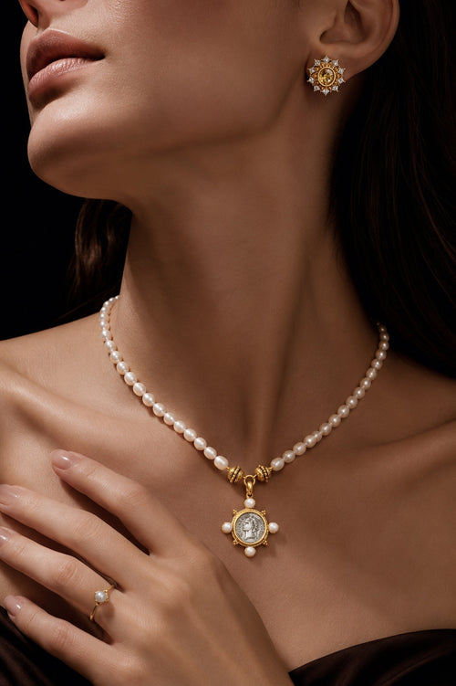 Pearl necklace and pendant styled close to the neckline