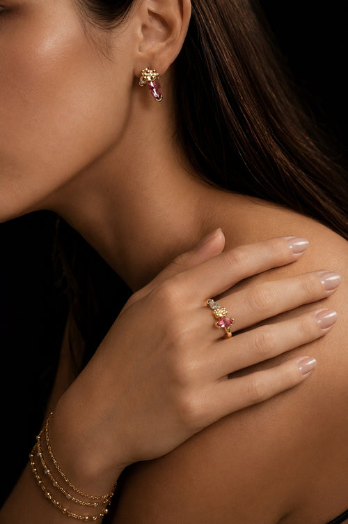 Green statement jewellery worn with quiet confidence